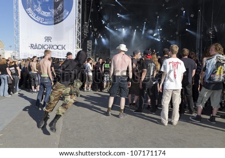 HELSINKI, FINLAND - JUNE 29: Unidentified Fans moshing at gig of american heavy metal band Trivium June 29, 2012 at 15th annual Tuska Open Air Metal Festival in Suvilahti, in Helsinki, Finland.