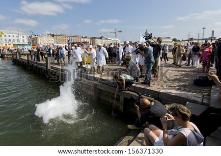 HELSINKI FINLAND-JULY 25:Finnish Unscientific Society throwing Cold Stone on Jaakko\'s Day July 25,2013 at Cholera Basin in Helsinki,Finland.According to Finnish belief throwing cold stone cools lakess
