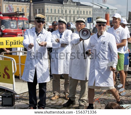 HELSINKI FINLAND-JULY 25:Finnish Unscientific Society throwing Cold Stone on Jaakko\'s Day July 25,2013 at Cholera Basin in Helsinki,Finland.According to Finnish belief throwing cold stone cools lakess