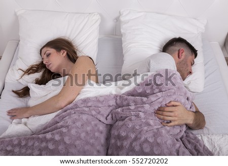 couple in bed sleeping after quarrel Foto stock © 