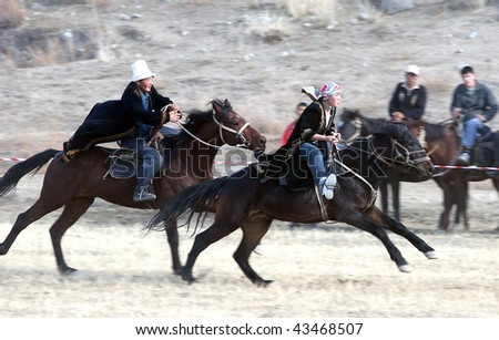 KYRGYZSTAN - JULY 21: The \'Kiss the Bride\' race proves popular at the Central Asian Horse Games on July 21, 2009 in Kyrgyzstan