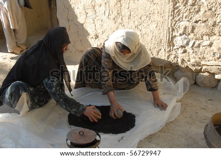 BAHARAK, AFGHANISTAN - JUNE 2: Afghan women demonstrate the manufacture of bio briquettes for cooking fuel on June 2, 2010 in Baharak, Afghanistan
