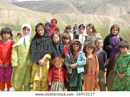 NECHEM, AFGHANISTAN - MAY 28: School girls pose together on May 28, 2010 in Nechem, Afghanistan. A decade ago not a single girl in Badakhshan was in school but now the majority get primary education.