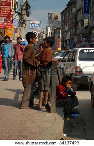 KATHMANDU, NEPAL - MARCH 1: Young boy sniffs glue from a plastic bag on March 1, 2010 in Kathmandu, Nepal. Drug dependency is a growing problem in the city.