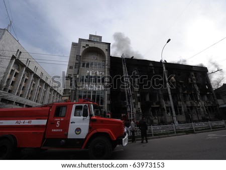 BISHKEK, KYRGYZSTAN - APRIL 8: Fire crews attempt to put out fires at the burned out Ministry of Justice on April 8, 2010 in Bishkek, Kyrgyzstan. The building was set alight during the revolution.