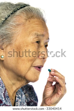 Grandmother eat green medicine with white background