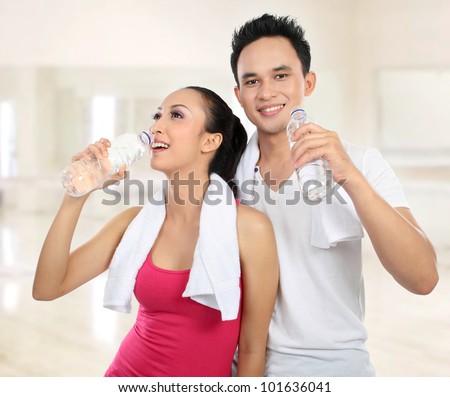 https://image.shutterstock.com/display_pic_with_logo/441070/101636041/stock-photo-portrait-of-sporty-healthy-young-woman-and-man-drinking-water-in-the-gym-101636041.jpg