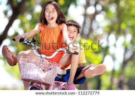 happy smiling kids enjoy riding bicycle together outdoor