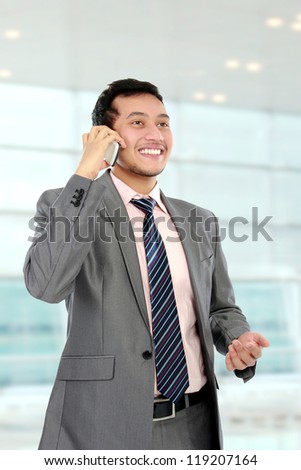 busy young business man hold the cellphone
