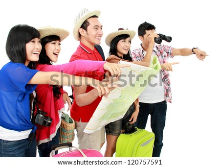 Happy young people tourists pointing to a direction
