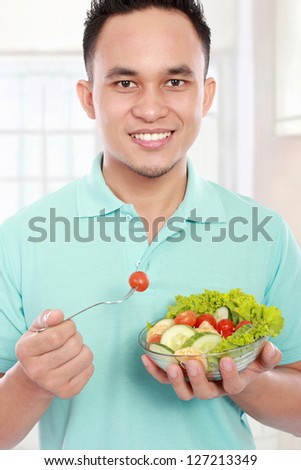 young men eating salad. Healthy lifestyle concept