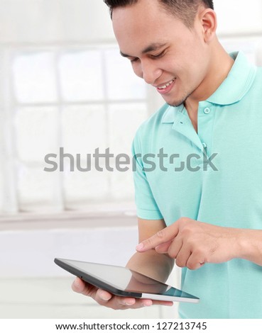 portrait of Smiling young man with tablet computer
