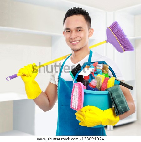 portrait of man with cleaning equipment cleaning the house