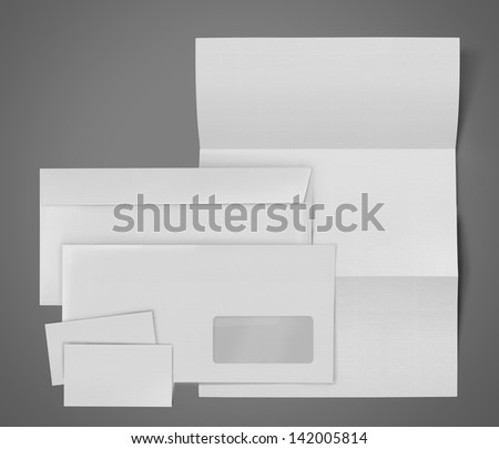 business stationary set. envelope, sheet of paper and business card on gray background