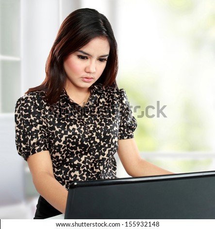 Portrait of successful businesswoman working with laptop over white background