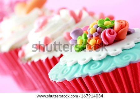 close up of beautiful colorful wedding cupcakes