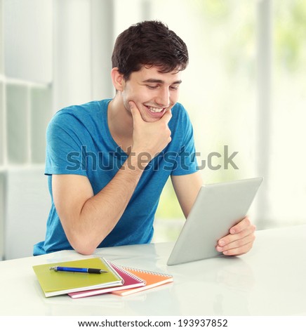 portrait of happy young student using tablet pc