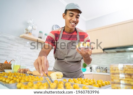 Similar – Foto Bild Männlicher Bäcker schiebt Kuchen in den Ofen