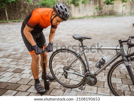 Similar – Image, Stock Photo Inflate bike tires