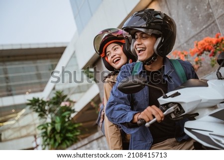 happy asian man and woman riding a motorcycle Imagine de stoc © 