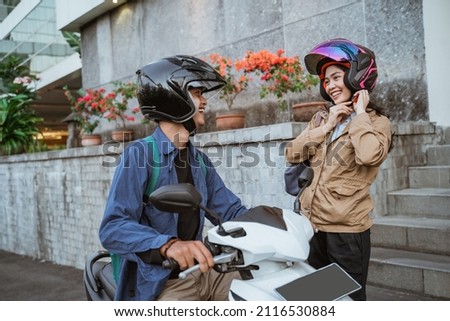 asian man on a motorbike picks up a woman Photo stock © 