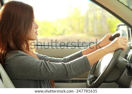 portrait of young beauty woman driving a car