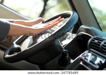 close up portrait of hands on wheel steering and horn