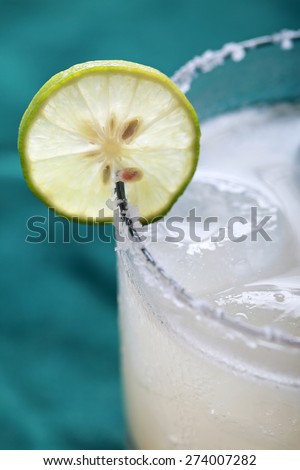 close up portrait of Classic margarita cocktail with lime and salty rim