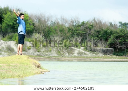 portrait of young boy feel relax at the lakeside during summer vacation