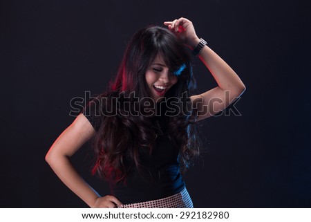 A portrait of young woman dancing on the disco party