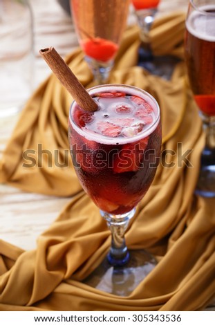 a glass of red sangria with cinnamon for refrehments