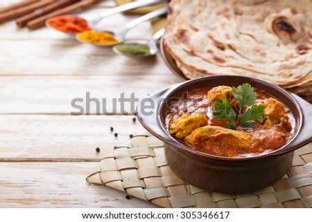 portrait of indian chicken curry and prata bread  with copyspace