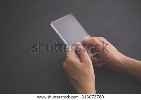 A portrait of a blank glass square on black background, futuristic transparent smart phone mock up
