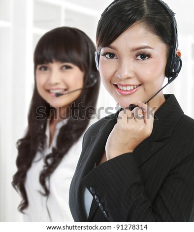 Portrait of a successful female call centre employee wearing a headset. in white background