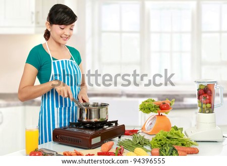 Beautiful woman cooking something in the kitchen