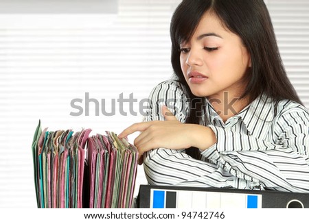 Portrait of stress business woman looking for document