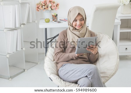 Similar – Foto Bild Muslimische Frau mit Tablet auf der Couch