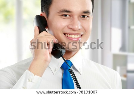 close up portrait of Handsome business man calling by phone at the office