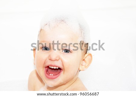 Adorable bath baby boy with soap suds on hair