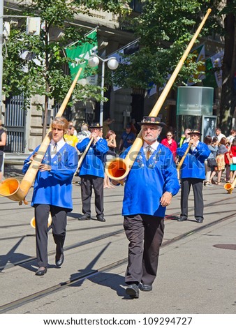 ZURICH - AUGUST 1: Swiss National Day parade on August 1, 2009 in Zurich, Switzerland. Representative of canton Schwyz in a historical costume with traditional instrument Alphorn.