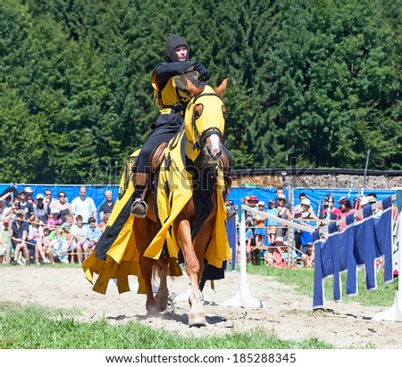 AGASUL, SWITZERLAND - AUGUST 18: Unidentified man in knight armor on the horse during tournament reconstruction near Kyburg castle on August 18, 2012 in Agasul, Canton Zurich, Switzerland.