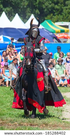 AGASUL, SWITZERLAND - AUGUST 18: Unidentified man in knight armor on the horse during tournament reconstruction near Kyburg castle on August 18, 2012 in Agasul, Canton Zurich, Switzerland.