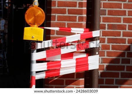 Similar – Image, Stock Photo red-white barrier beacons in front of a richly decorated but slowly decaying residential house with yellow-brown clinker facade from the Gründerzeit / dilapidated / lost place