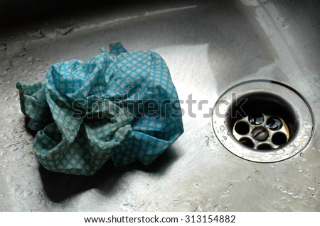 Plug Hole in Kitchen Sink with Dirty Dish Cloth