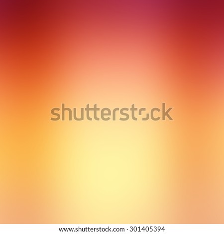 warm autumn background blur in red pink gold yellow and orange with light center and smooth shiny background texture, colorful background design