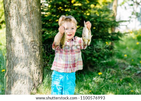 Similar – Image, Stock Photo child holding a fish and showing it to the camera