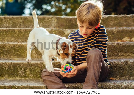 Similar – Image, Stock Photo Child kindly caresses his dog