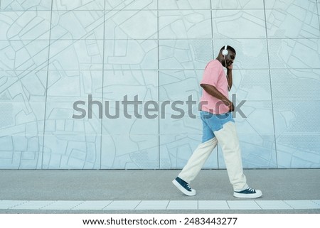 Similar – Image, Stock Photo Man walking down a staircase between two imposing buildings