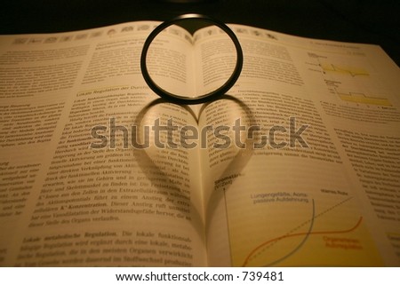Shadow of a lens on a book looks like a heart