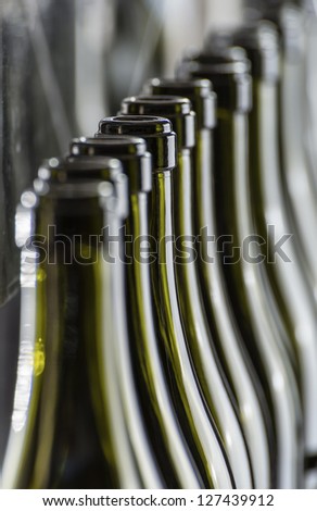 Italy, Sicily, wine bottles ready to be washed and filled with wine by an industrial machine in a wine factory